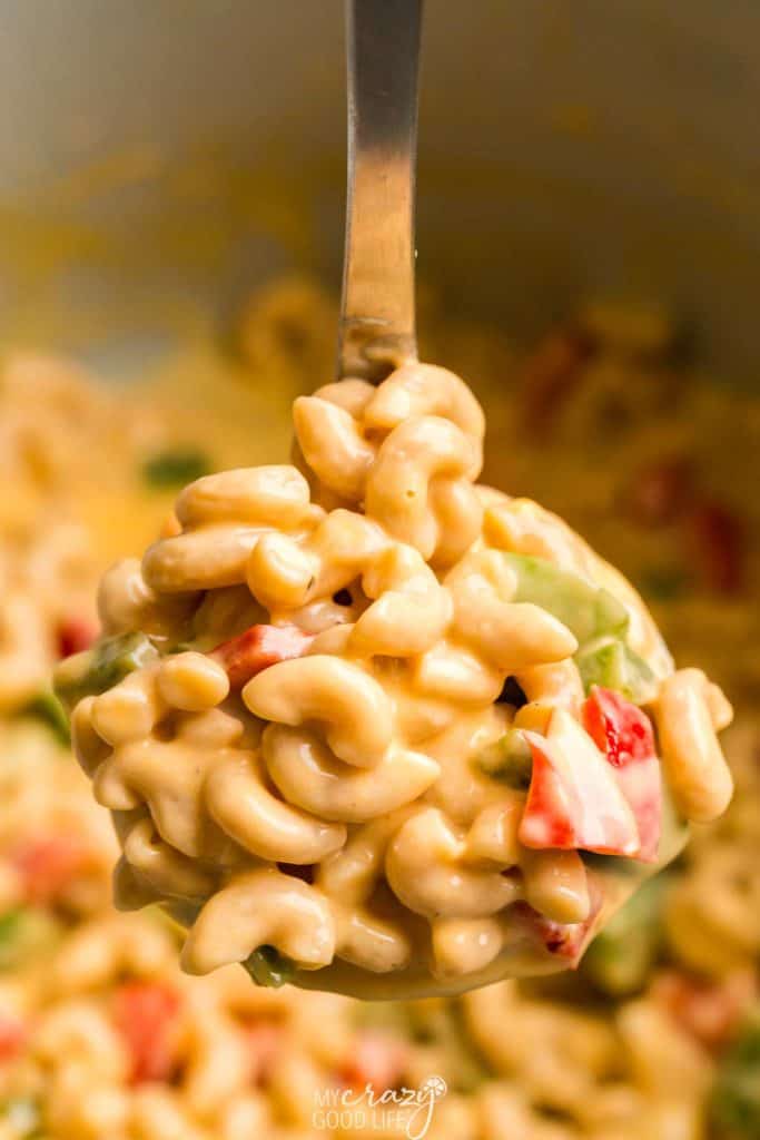 close up of healthy macaroni and cheese on a large spoon