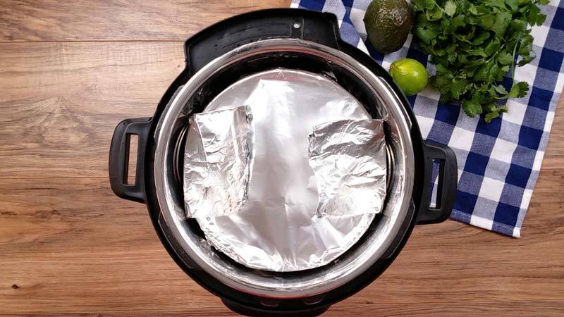 top down of instant pot with a foil covered pot inside