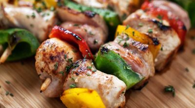 close up of chicken skewer on cutting board