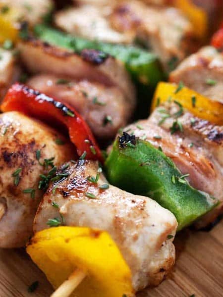 close up of chicken skewer on cutting board