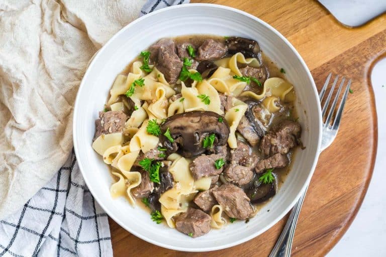 white bowl on a wood counter with beef stroganoff
