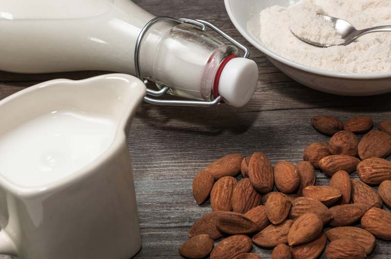 almonds and almond milk containing gellan gum, on table