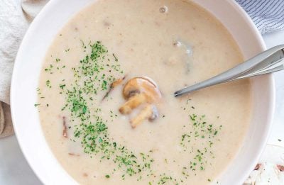 close up of cream of mushroom soup in white bowl