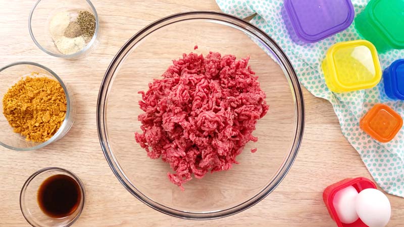 ground beef in clear bowl, spices, and soy sauce