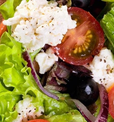 close up of salad in a red bowl