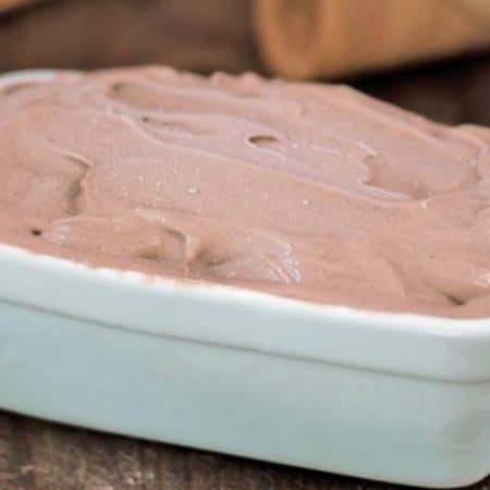 A white rectangular dish full of frozen chocolate banana ice cream.