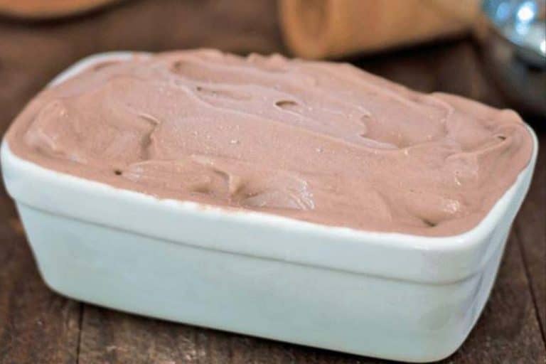 A white rectangular dish full of frozen chocolate banana ice cream.