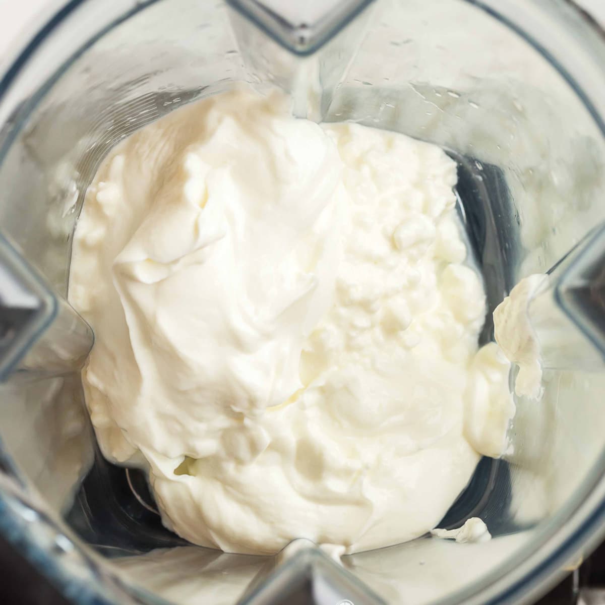 cottage cheese and greek yogurt inside of a blender.
