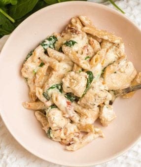 top down image of chicken pasta in a white bowl