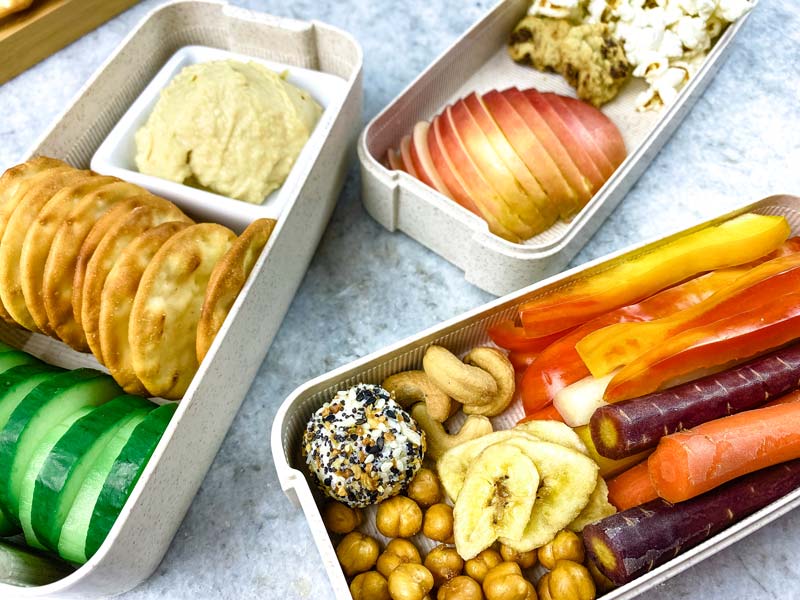 close up of vegetables and snacks in a charcuterie lunch box