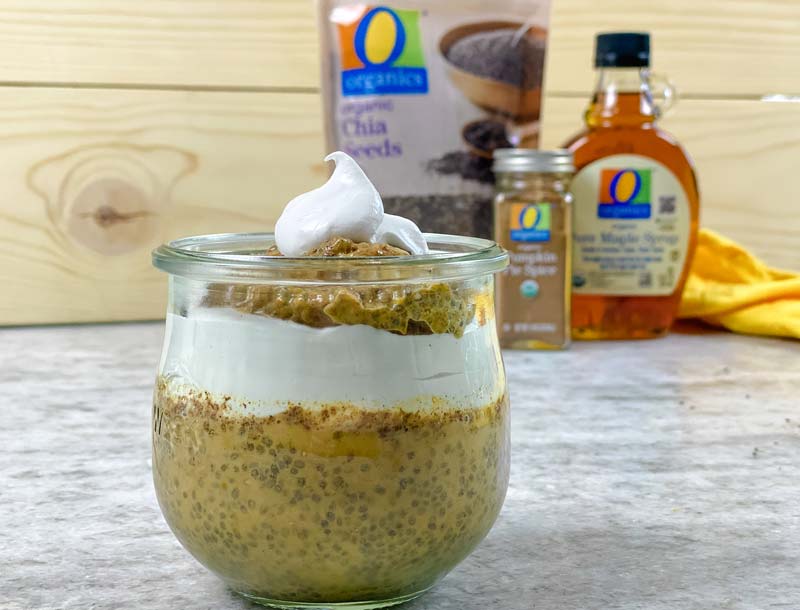 close up of chia pudding with ingredients in back