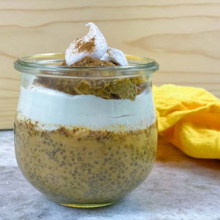 pumpkin spice chia pudding layered with coconut whipped cream