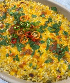 close up of corn dip in a baking dish