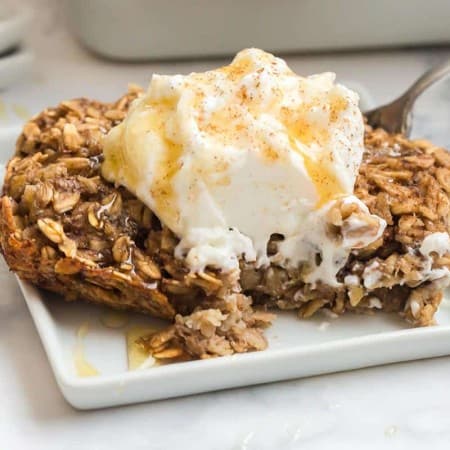 slice of baked banana bread oatmeal with almond yogurt and agave