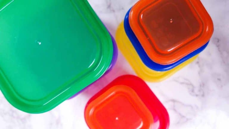 Marble countertop with 21 Day Fix colored containers in 3 stacks.