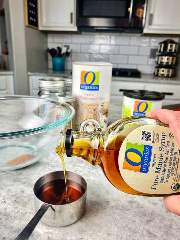 Photo of maple syrup being poured into a measuring cup.
