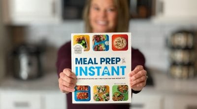 Becca holding the book Meal Prep in an Instant