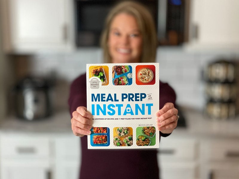 Becca holding a book, Meal Prep in an Instant