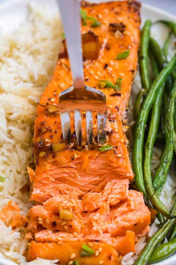 close up of salmon with fork showing how flaky it is