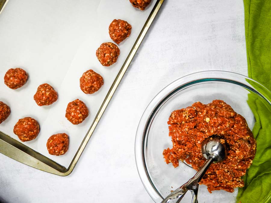meatballs being measured with a cookie scoop