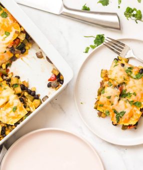 vegetarian mexican casserole in white dish with slice removed