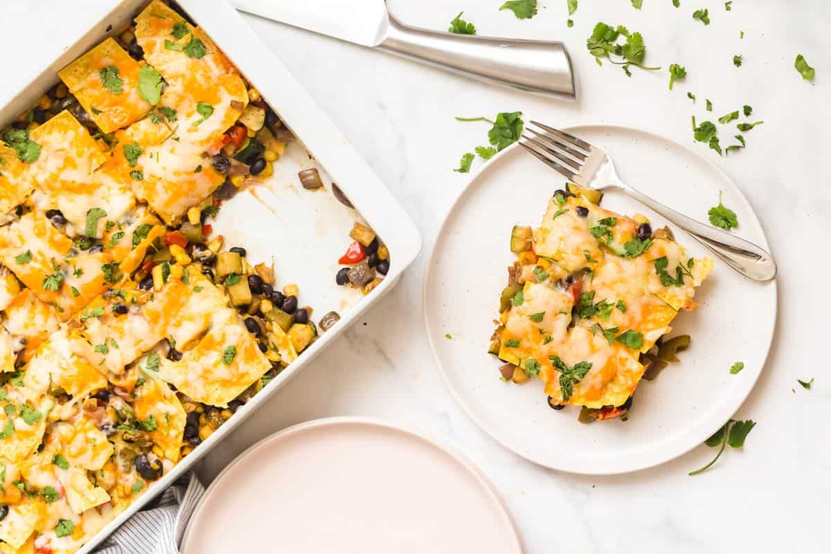 vegetarian mexican casserole in white dish with slice removed