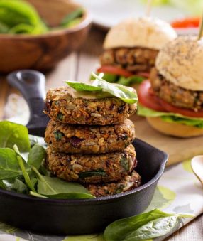 three veggie burgers stacked on top of one another in a cast iron skillet