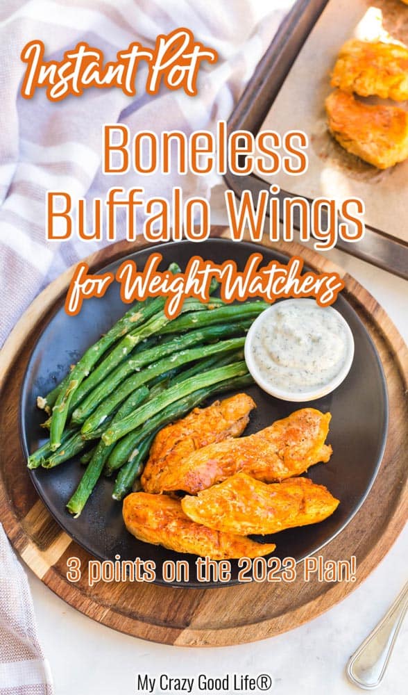 black plate with cooked boneless buffalo wings and green beans, with small white dish of ranch dressing on the side. There is text on the image for Pinterest. 