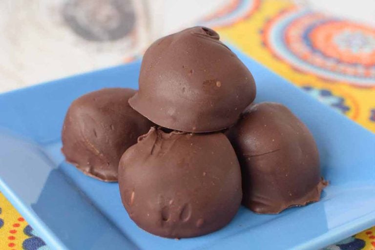 Blue plate with a stack of peanut butter buckeyes on stop.