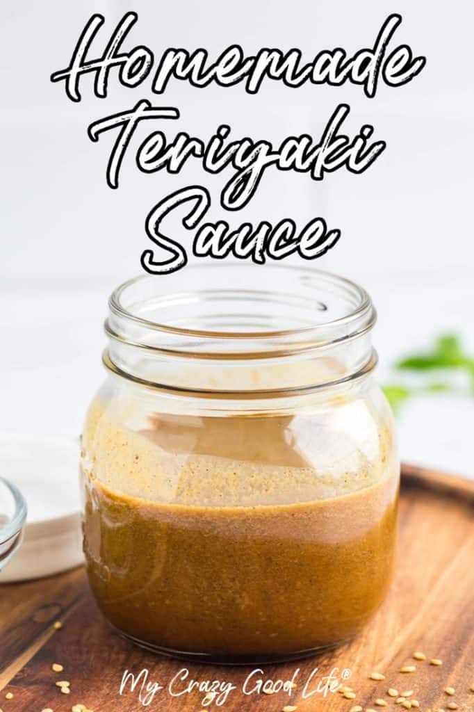 small mason jar half full of teriyaki sauce on a wood charger with sesame seeds scatter around. Text on image with recipe and blog name. 