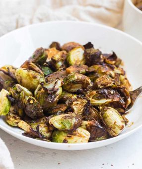 teriyaki brussels sprouts in a white bowl