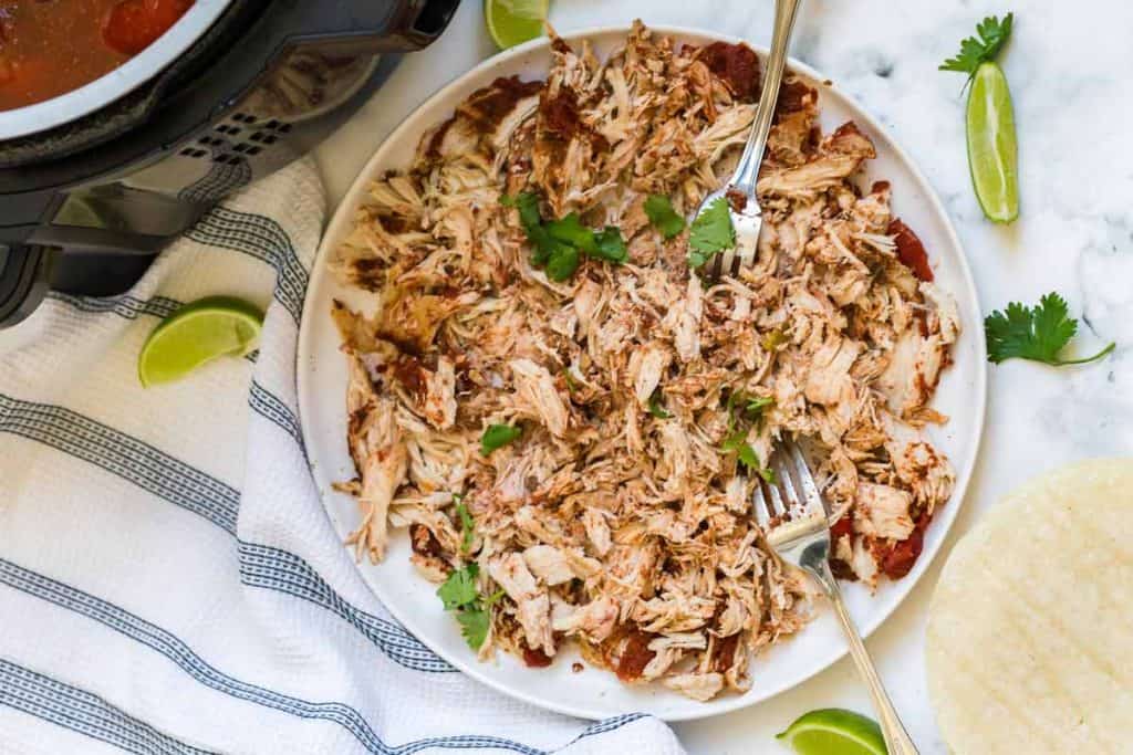large  bowl filled with shredded chicken fajitas