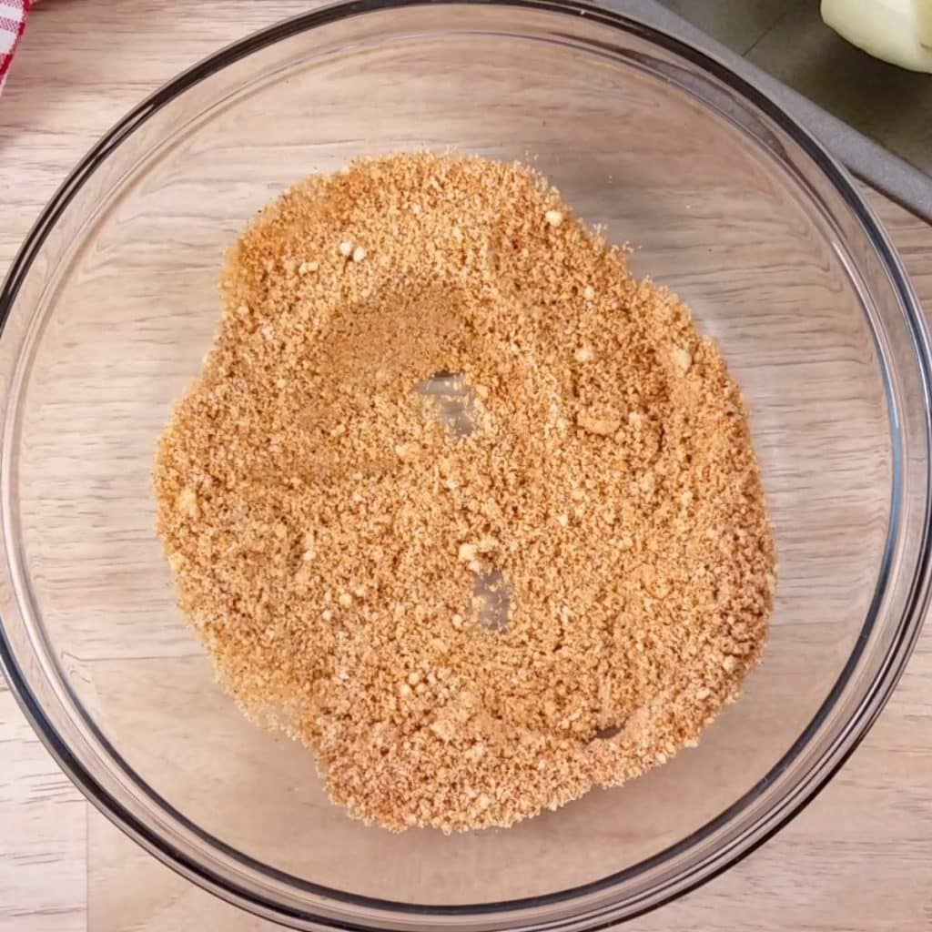 A small bowl filled with spices and seasonings for a blooming onion.