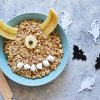 bowl of oatmeal with sliced banana to look like horns and marshmallows to look like teeth