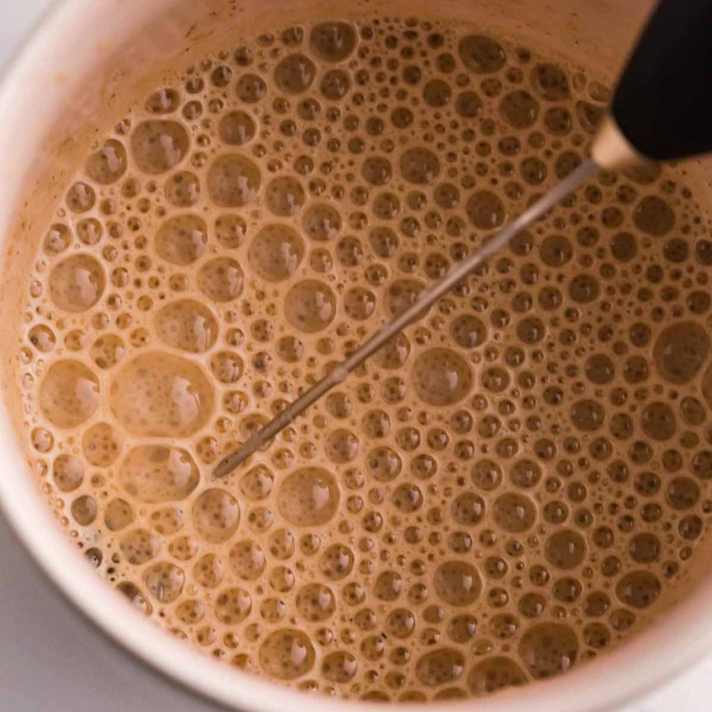Pumpkin Cream Cold Foam being frothed with a small black milk frother.