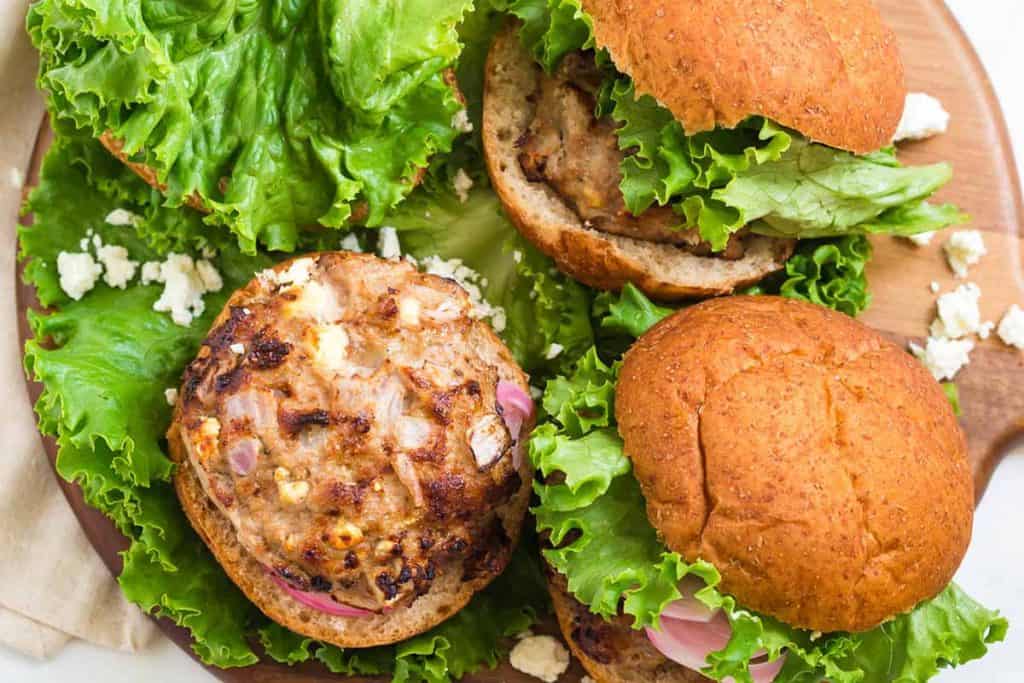 ranch turkey burgers on a bed of lettuce and in whole grain buns