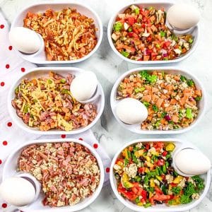 Six white dishes with six different flavors of Just Crack an Egg recipes in them.