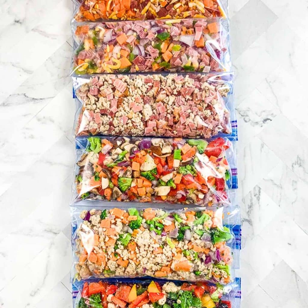 Six zipper bags for the freezer with six different flavors of Just Crack an Egg recipes in them.