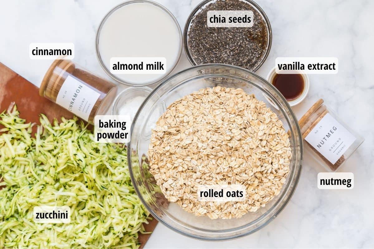 A white and gray marbled counter top with labeled ingredients needed to make Zucchini Bread Baked Oatmeal.