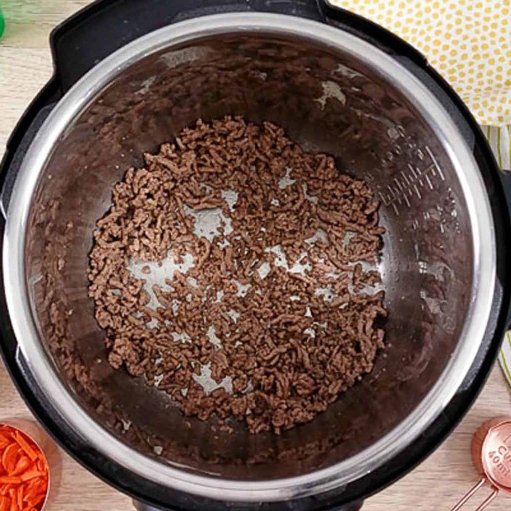 Open Instant pot with sautéing ground beef.  