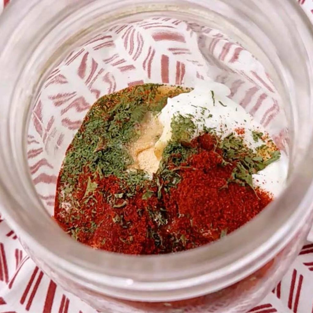 greek yogurt, spices, and water in a glass mason jar
