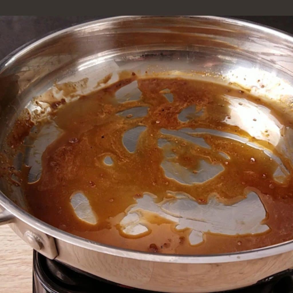 A stainless skillet with a homemade teriyaki sauce in it.