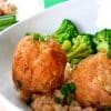 two teriyaki meatballs in a white bowl with broccoli and brown nice and topped with green onions.