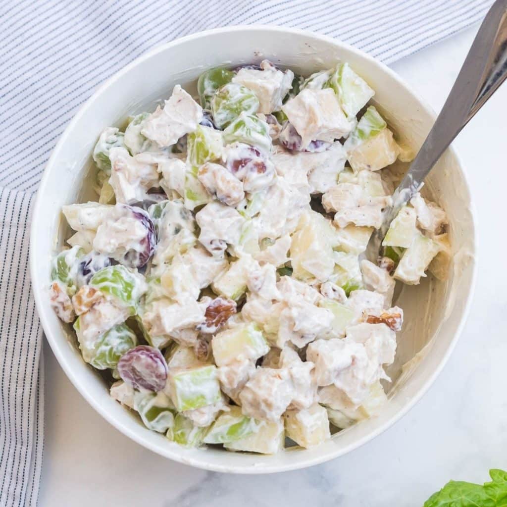 A white bowl of Weight Watchers Chicken Salad with Grapes all mixed together.