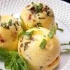 image of three egg bites on a white plate with fresh basil as garnish.