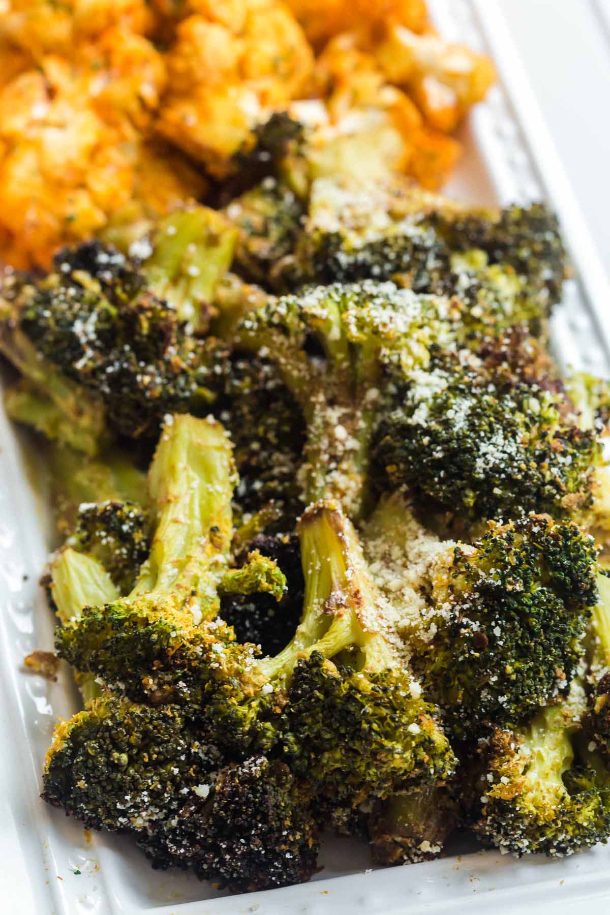 Air Fried broccoli and cauliflower on a white dish, cooked in the air fryer. 