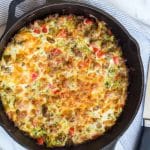 A large cast iron skillet with a baked zucchini breakfast casserole inside of it.