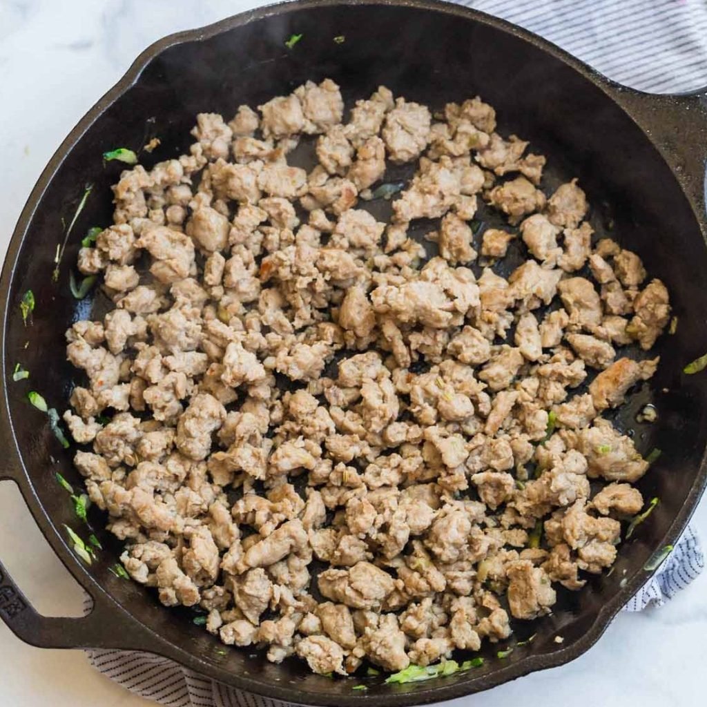 cast iron skillet with cooked sausage crumbles