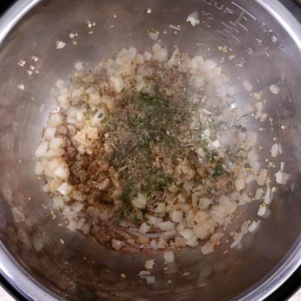Diced onions, garlic and herbs after being sautéed in an instant pot