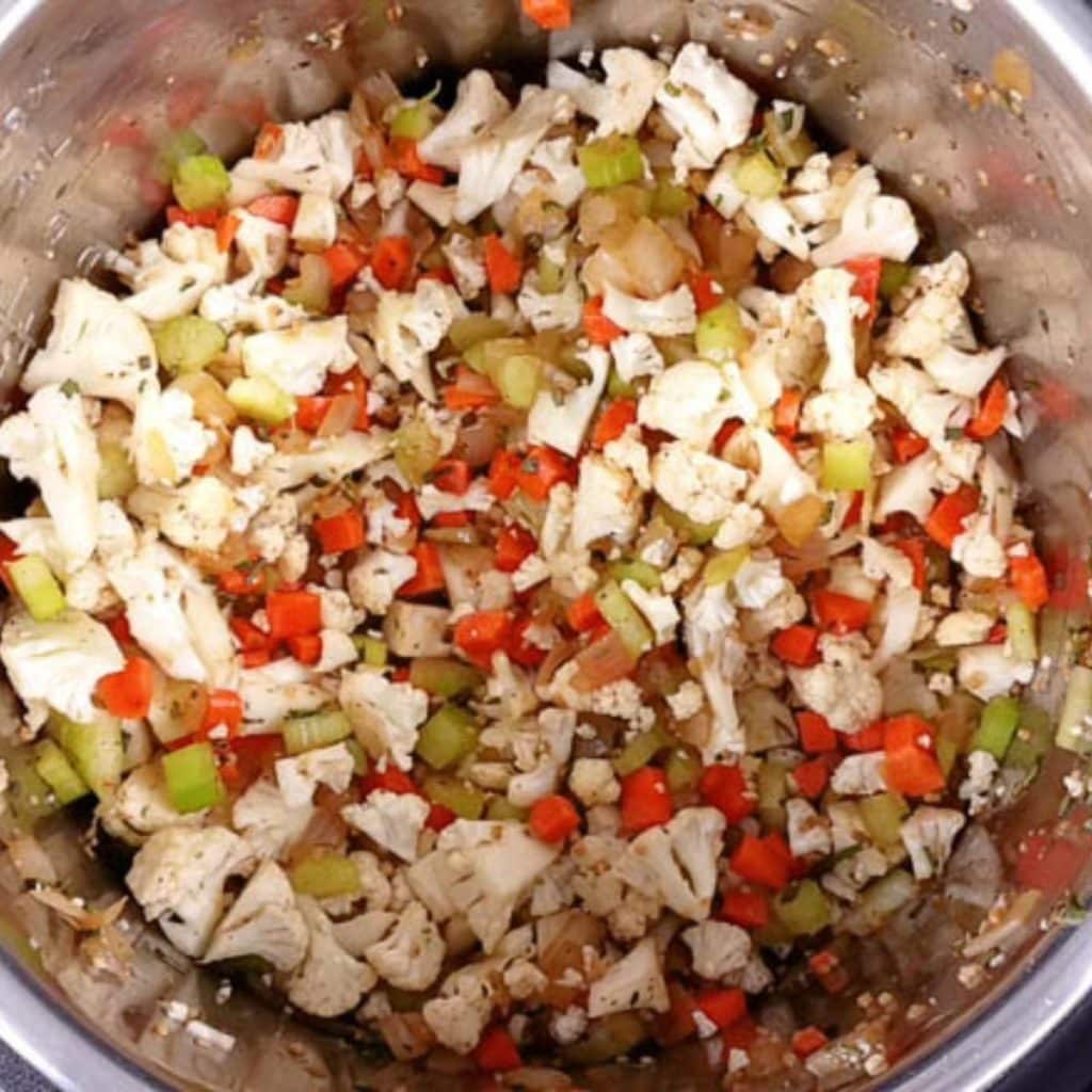 Cauliflower stuffing inside an instant pot before being cooked.